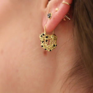 Polly Wales Coeur de Dentelle Padlock Earrings with Sapphires in 18k gold worn on the body 
